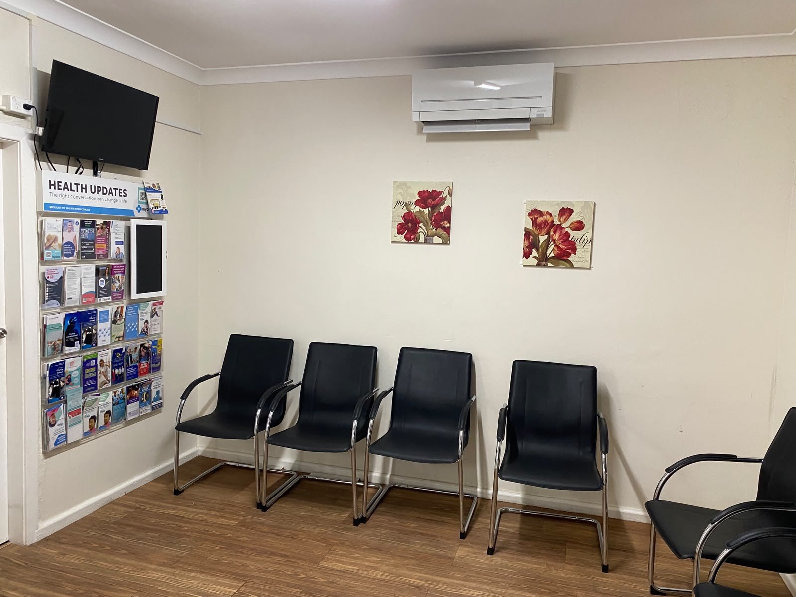 Waiting room with comfortable seating and a Health Updates brochure rack